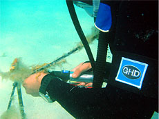 Diver using HOBO water shuttle to download data underwater