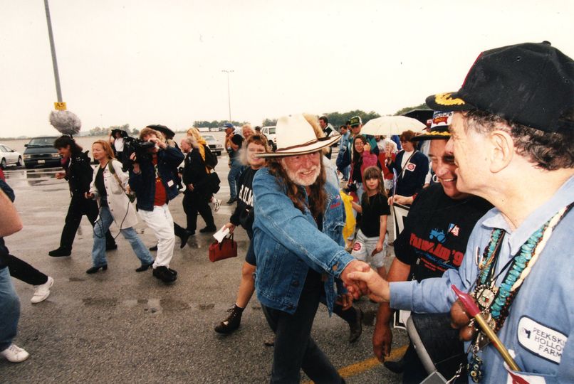 Willie Nelson shaking hands with farmer