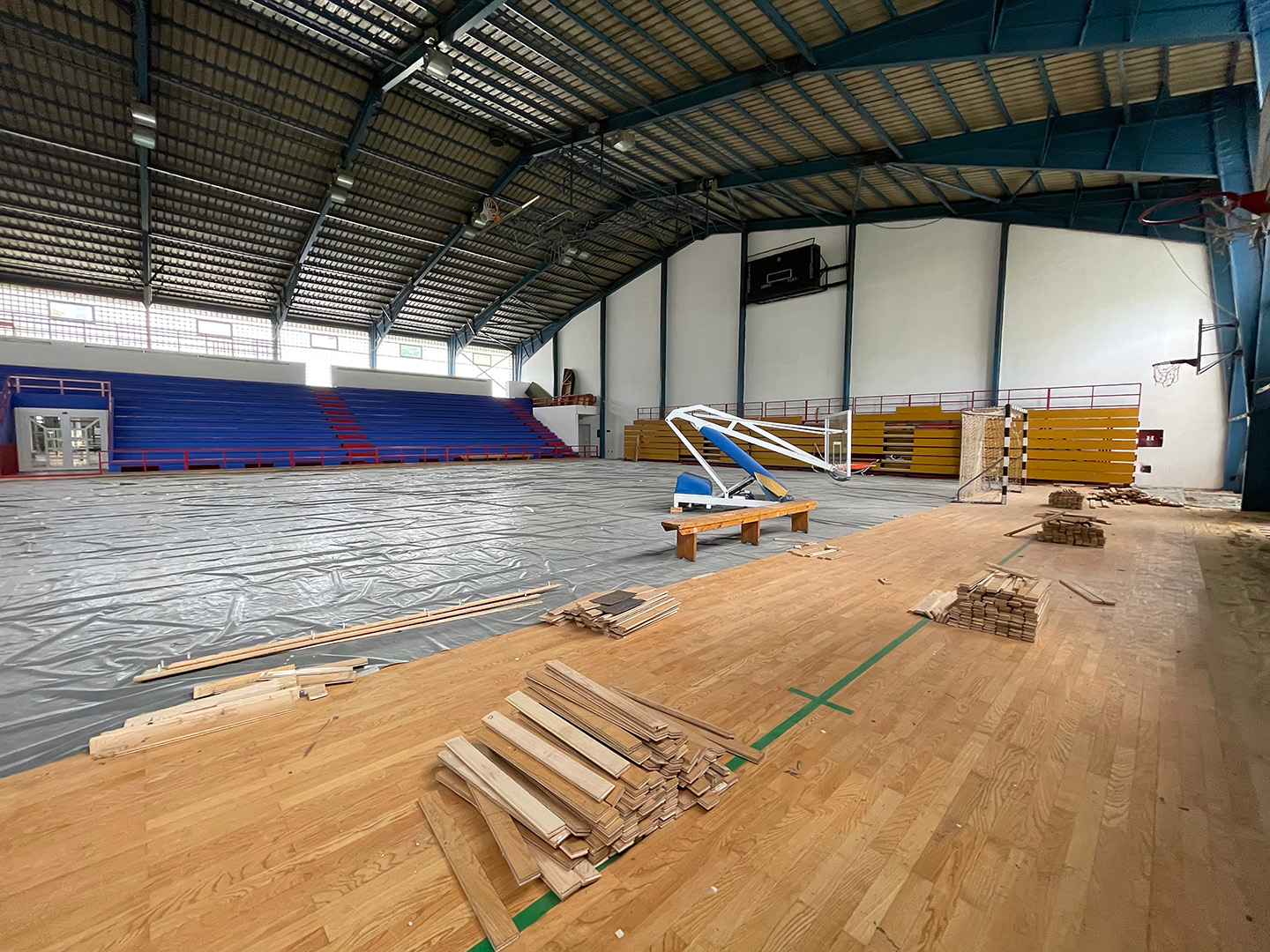 Gymnasium wood floor being replaced with new wooden planks