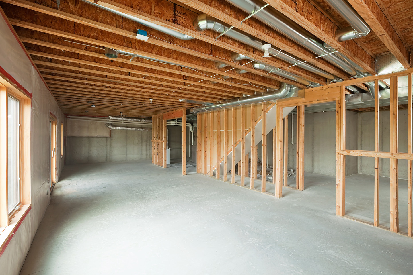 Interior of construction site with concrete subfloor and framing