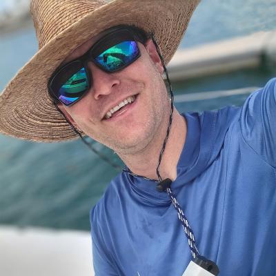 Austin Fox in hat on a boat