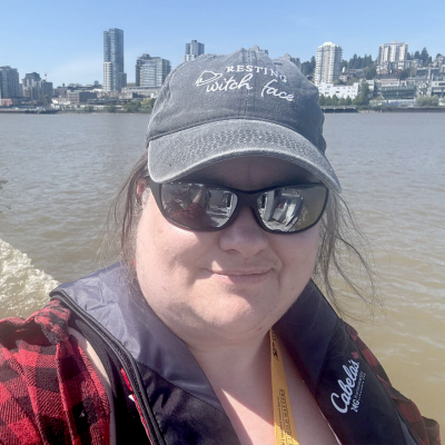 Jillian Stewart standing in front of water body with city in background