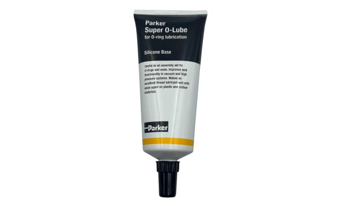 A tube of Parker Super O-Lube, a black and white toothpaste-type tube with a yellow stripe and black cap.