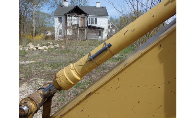 Tilt orientation meter installed on excavator in front of house