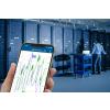 Phone in hand with app monitoring conditions in data center server room