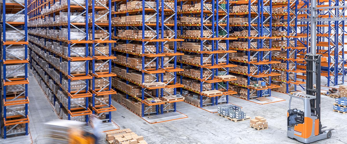 Inside of a large storage facility with racks of shelving
