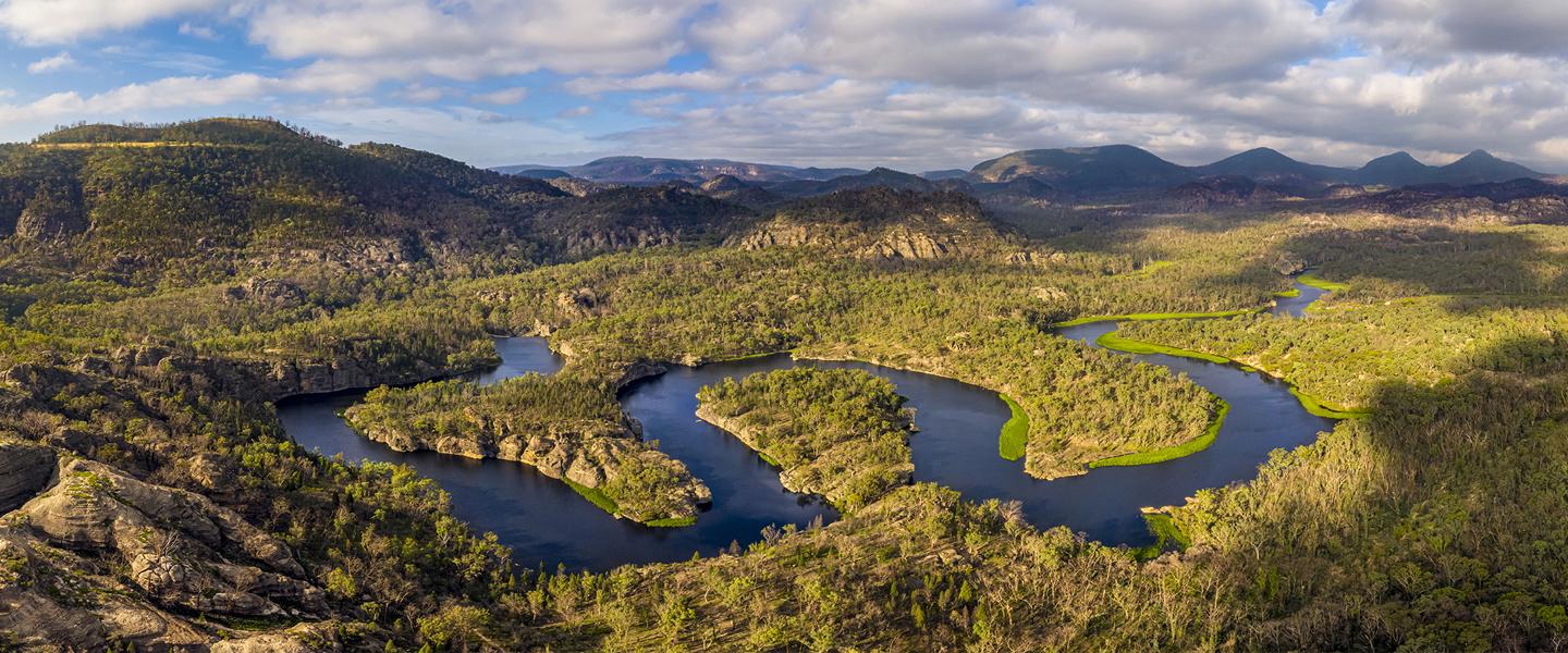 Body of water amongst the low lying mountains