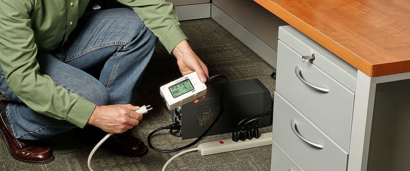 UX120-018 being used to monitor energy consumption in an office setting, under a desk.