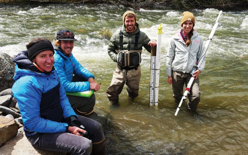 Ecologists from RiverNet stand in waders as they monitor Yellowstone River 