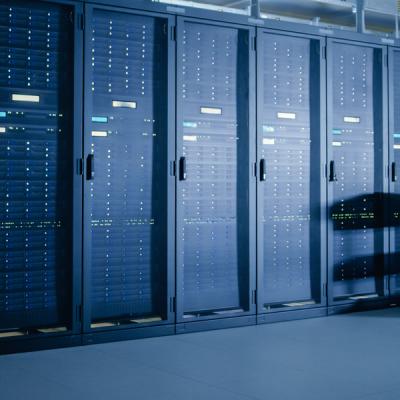 Man standing in front of large bank of data center equipment