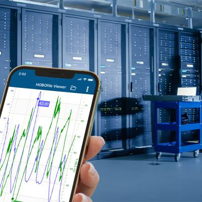 Phone in hand with app monitoring conditions in data center server room
