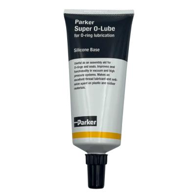 A tube of Parker Super O-Lube, a black and white toothpaste-type tube with a yellow stripe and black cap.